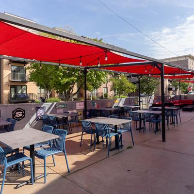 Covered patio, dining tables and chairs.