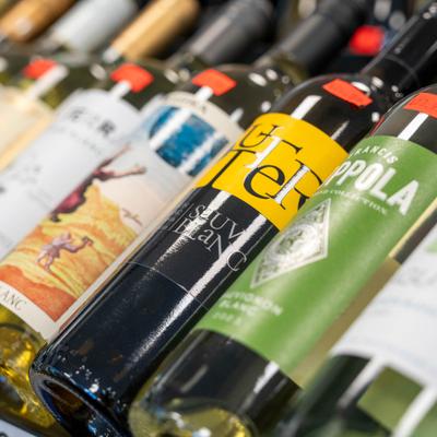 Wine bottles displayed on shelf.