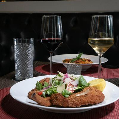 Milanese style pork rib served with red and white wine, and Penne alla Vodka.