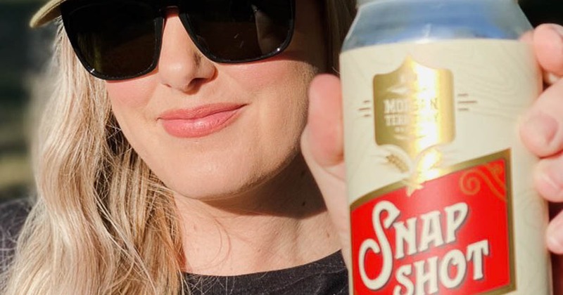 A person holding a canned drink