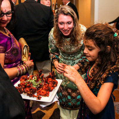 Young girls picking what to eat from a plate