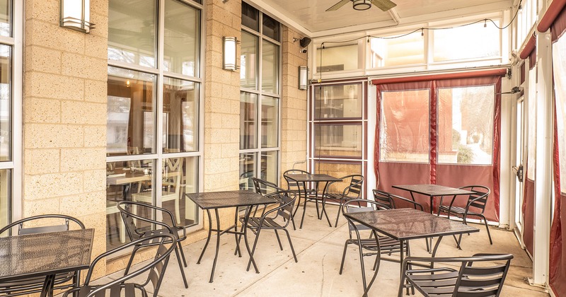 Covered patio with tables and chairs