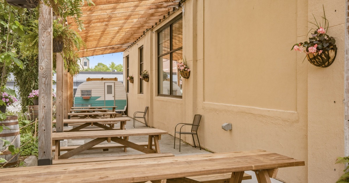 Covered patio with wooden picnic tables