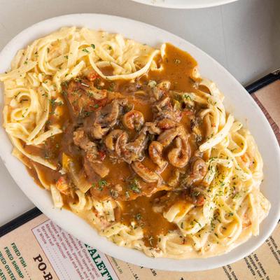 Bayou Chicken with sauteed crawfish, served over pasta with an etouffee sauce
