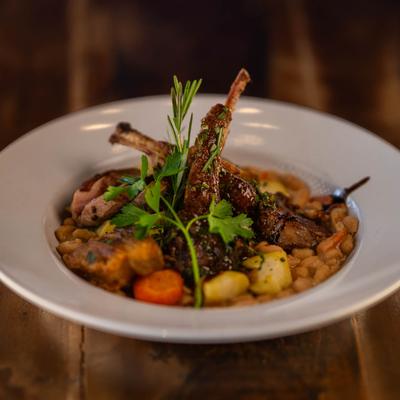 A plate of meat stew with vegetables.