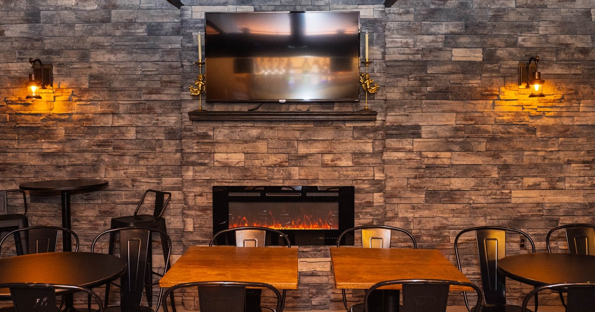 Tables and chairs by the fireplace