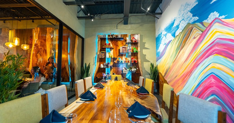 A well-decorated dining room with a long wooden table