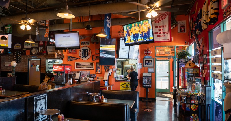 Interior, dining area, order service, hanging TV screens, wall decor