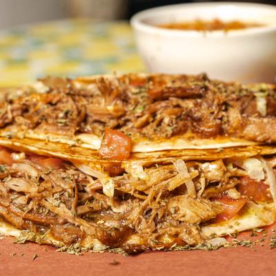 Pork tacos served with a dipp.