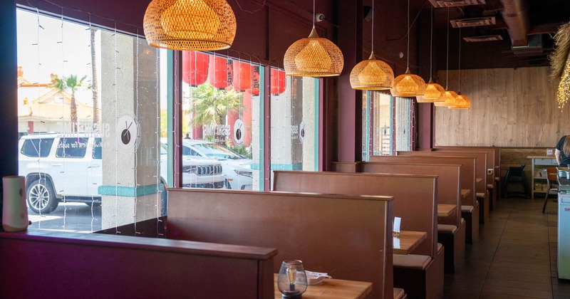 Interior, seating booths by the window, exterior view from the inside, hanging lanterns
