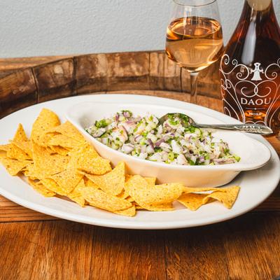 Shrimp Ceviche with chips, served with white wine on a barrel head.