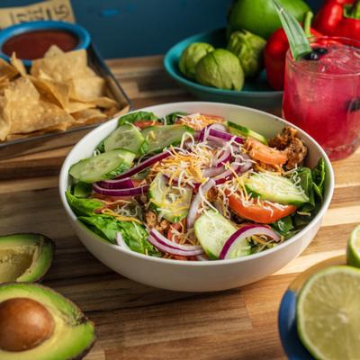 House Salad with tomatoes, cucumber, red onion, croutons, and shredded cheese.