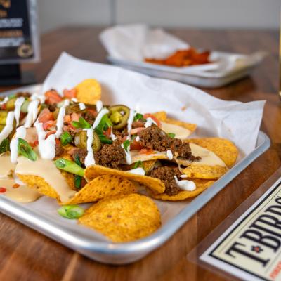 Loaded beef nachos, topped with jalapenos, pico de gallo and a drizzle of sauce.