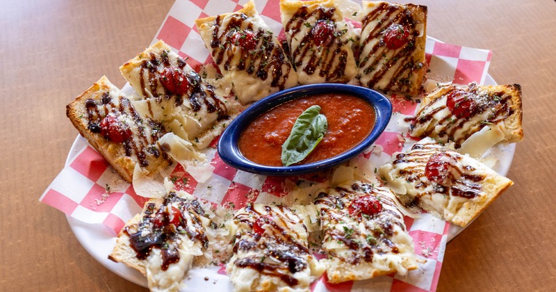 Bruschetta with cheese and balsamic glaze drizzle served with marinara sauce