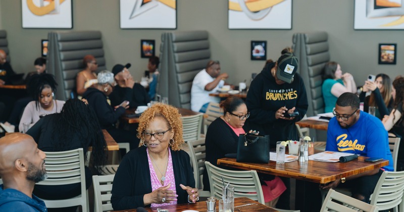 Diner area, tables, chairs, booths, people