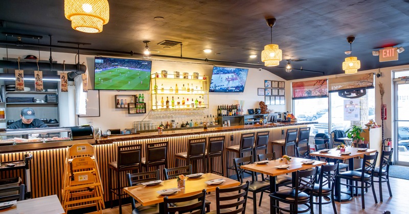 Interior, tables and chairs all lined up with the bar in the back