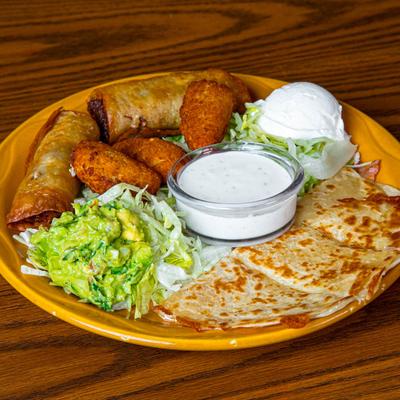 Sampler plate with poppers, mini quesadilla, flauta, guacamole, lettuce, and sour cream.