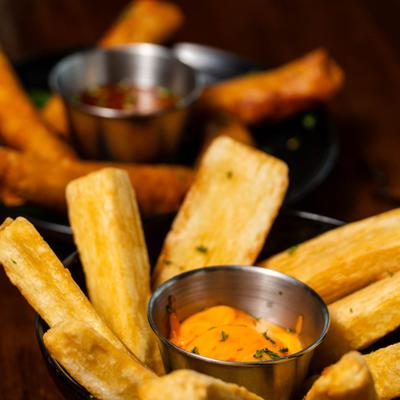 Fried yuca sticks with dipping sauce.