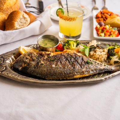 Grilled fish with rice and veggies.