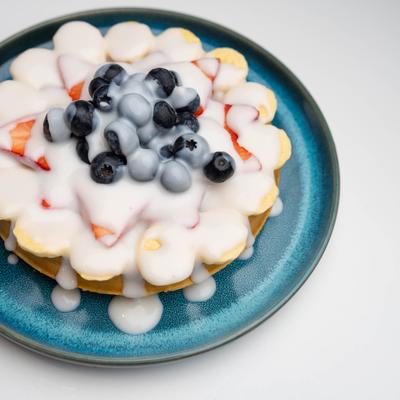 Hawaiian waffle topped with fruits and Hawaiian coconut sauce.