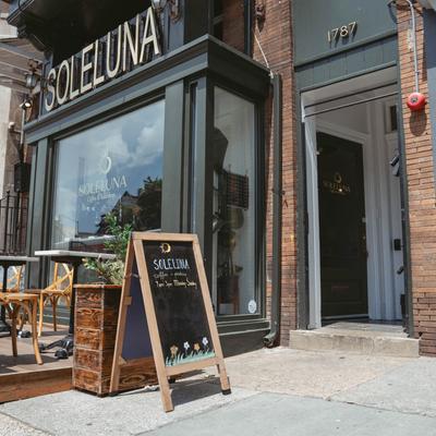 Exterior, front entrance, seating area and menu board.