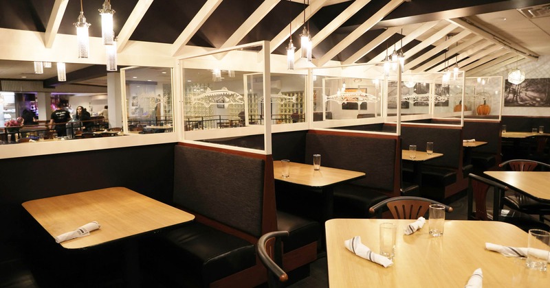 Interior, seating booths with tables, ready for guests, modern chandeliers