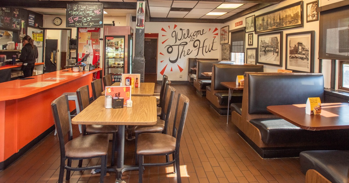 Interior of a diner with an orange counter, brown booths