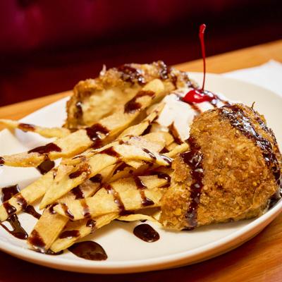 Fried ice cream drizzled with chocolate and tortilla strips.