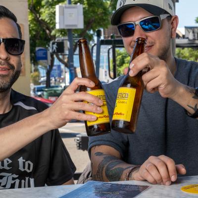 two men holding beers.