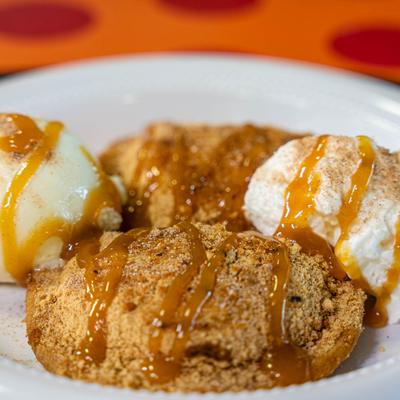 Apple Pie a La Mode, with whipped cream, vanilla ice cream, cinnamon sugar, and caramel drizzle.