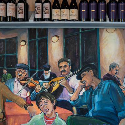 Mural art and wine bottles on a shelf above