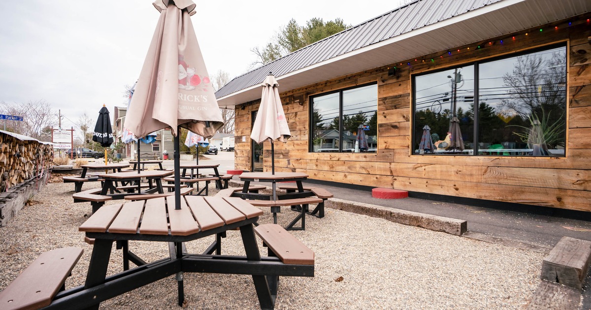 Outdoor seating area with picnic tables and parasols
