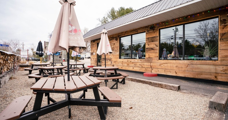 Outdoor seating area with picnic tables and parasols