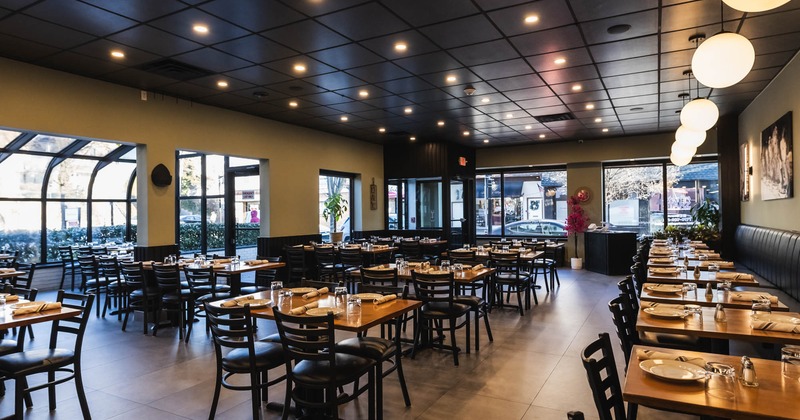Interior, wide view, set tables and chairs ready for guests