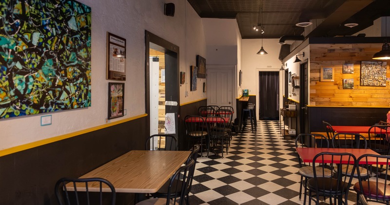 Interior, dining area, tables for four and two, black and white checkered floor tiles