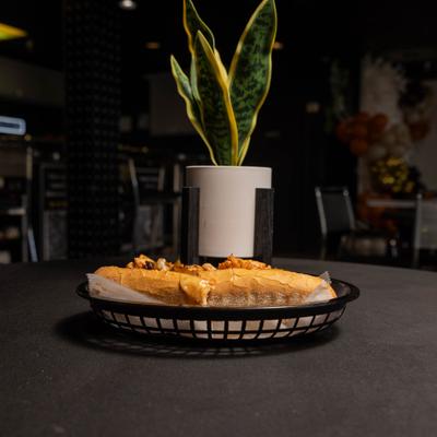 Jerk Chicken Cheesesteak sandwich served in a paper-lined basket.
