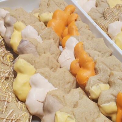 Assorted leaf-shaped cookies arranged neatly on a tray, close up.