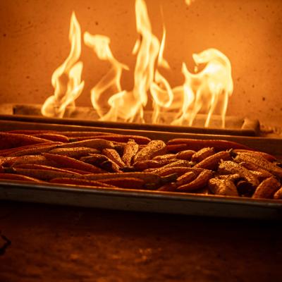 Carrots roasting in a pan by the fire