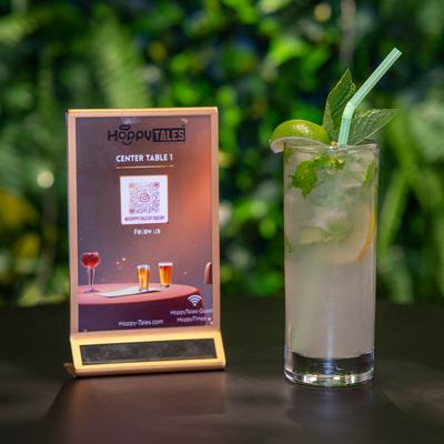 Mojito cocktail and a tabletop sign.