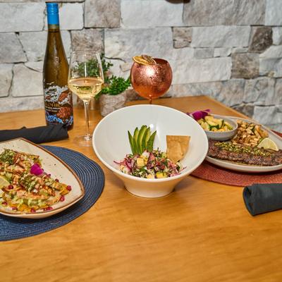 Served meal with white wine, and a cocktail in a copper cocktail glass.