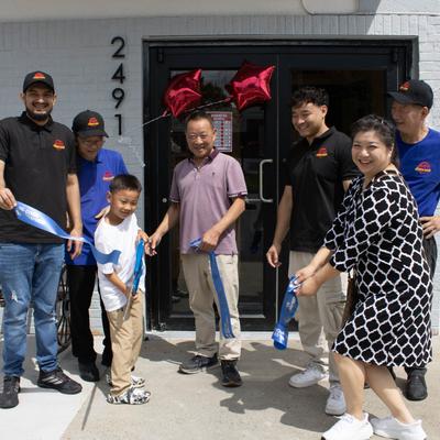 RIbbon cutting ceremony with giant scissors.