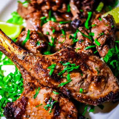 Grilled lamb chops garnished with parsley.