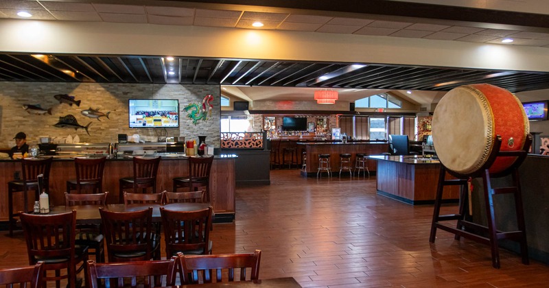 Interior, tables and chairs, bar in the back