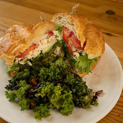 Chicken salad croissant with kale salad.