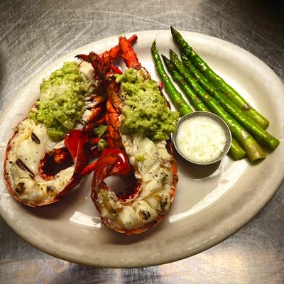 Whole lobster in shell served with Pesto risotto and asparagus.