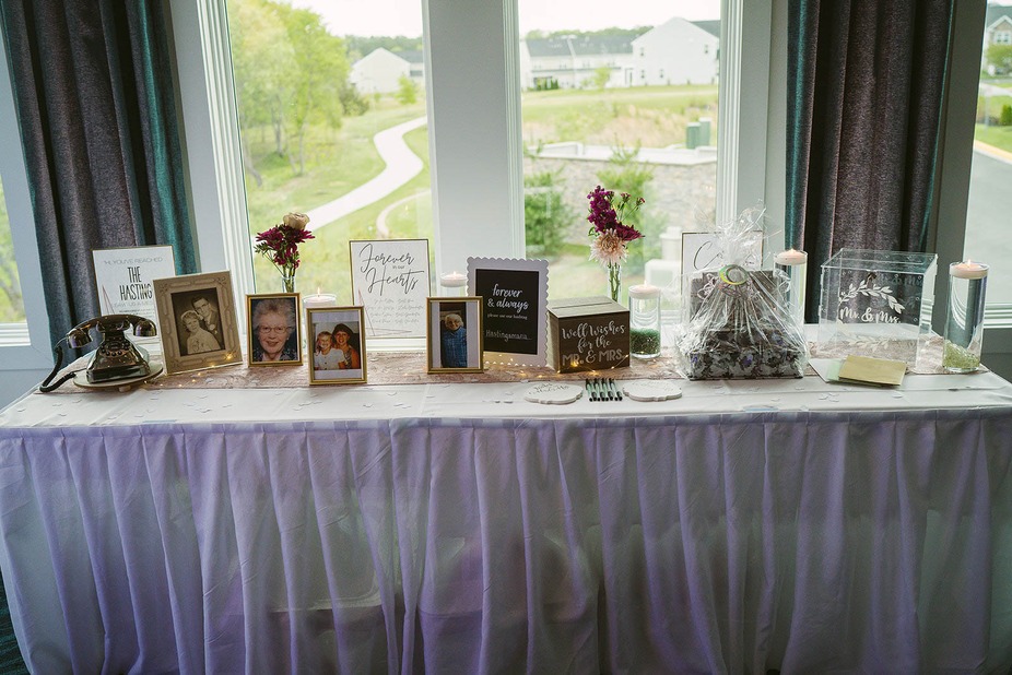 Table with framed pictures and well wishes to the couple