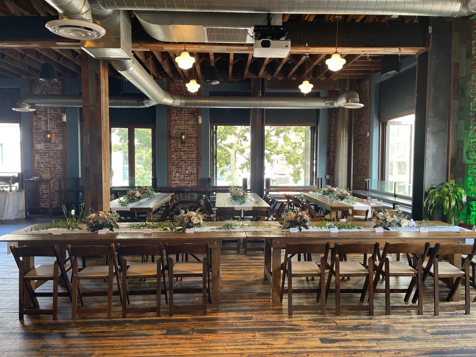 An event room long tables with chairs and floral decorations