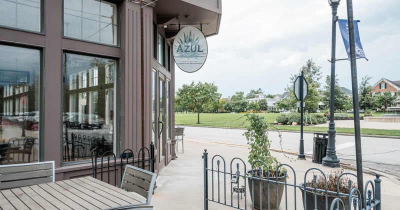 Outdoor view of the restaurant featuring wooden tables