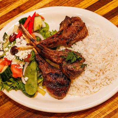 Lamb chops with rice and salad.