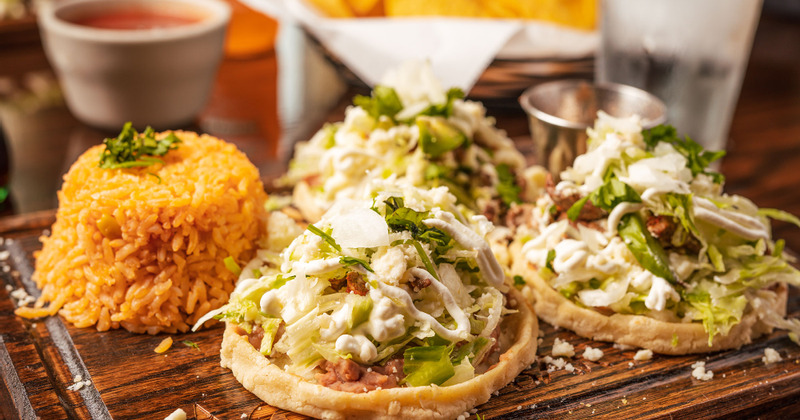 Baked pastry with vegetables, sliced meat and sauce, rice on the side